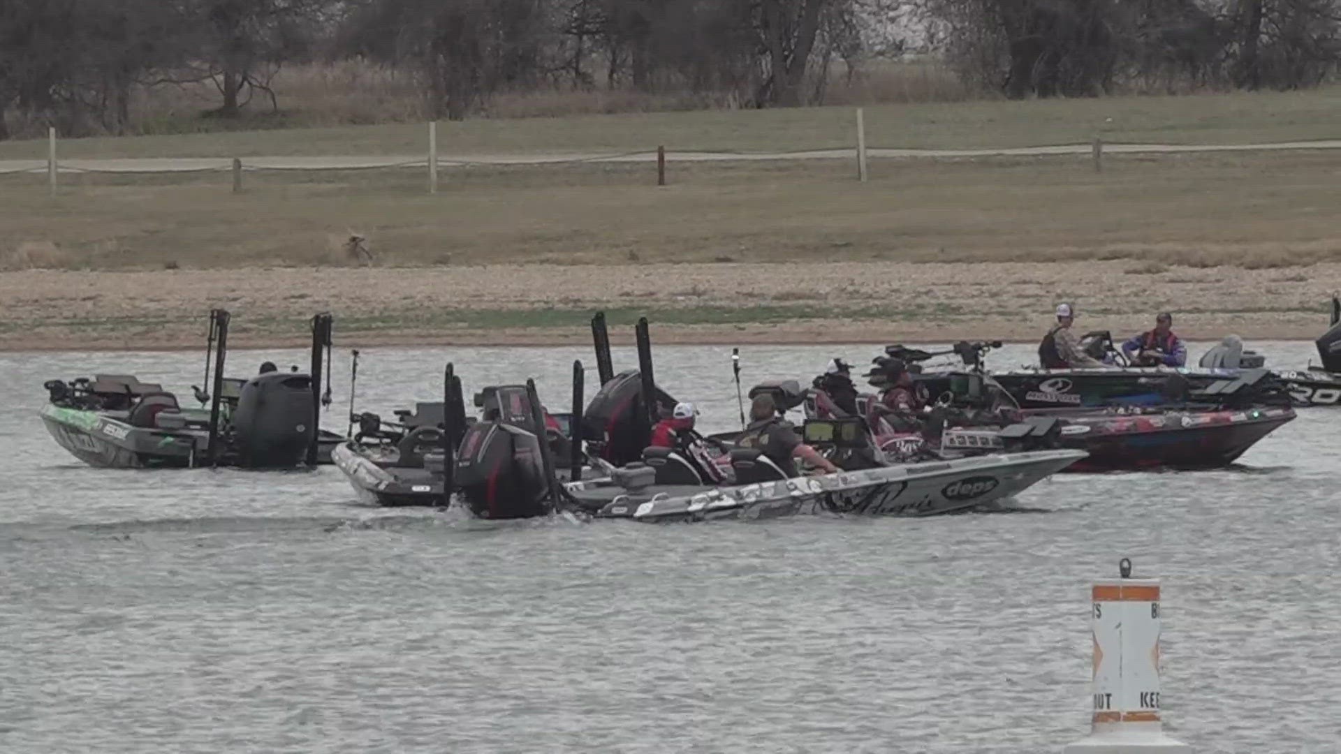 Bass boat in tournament fishing action on a lake