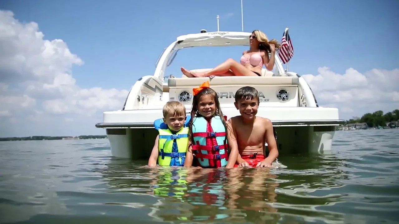 Family cruising on a bowrider across a calm lake