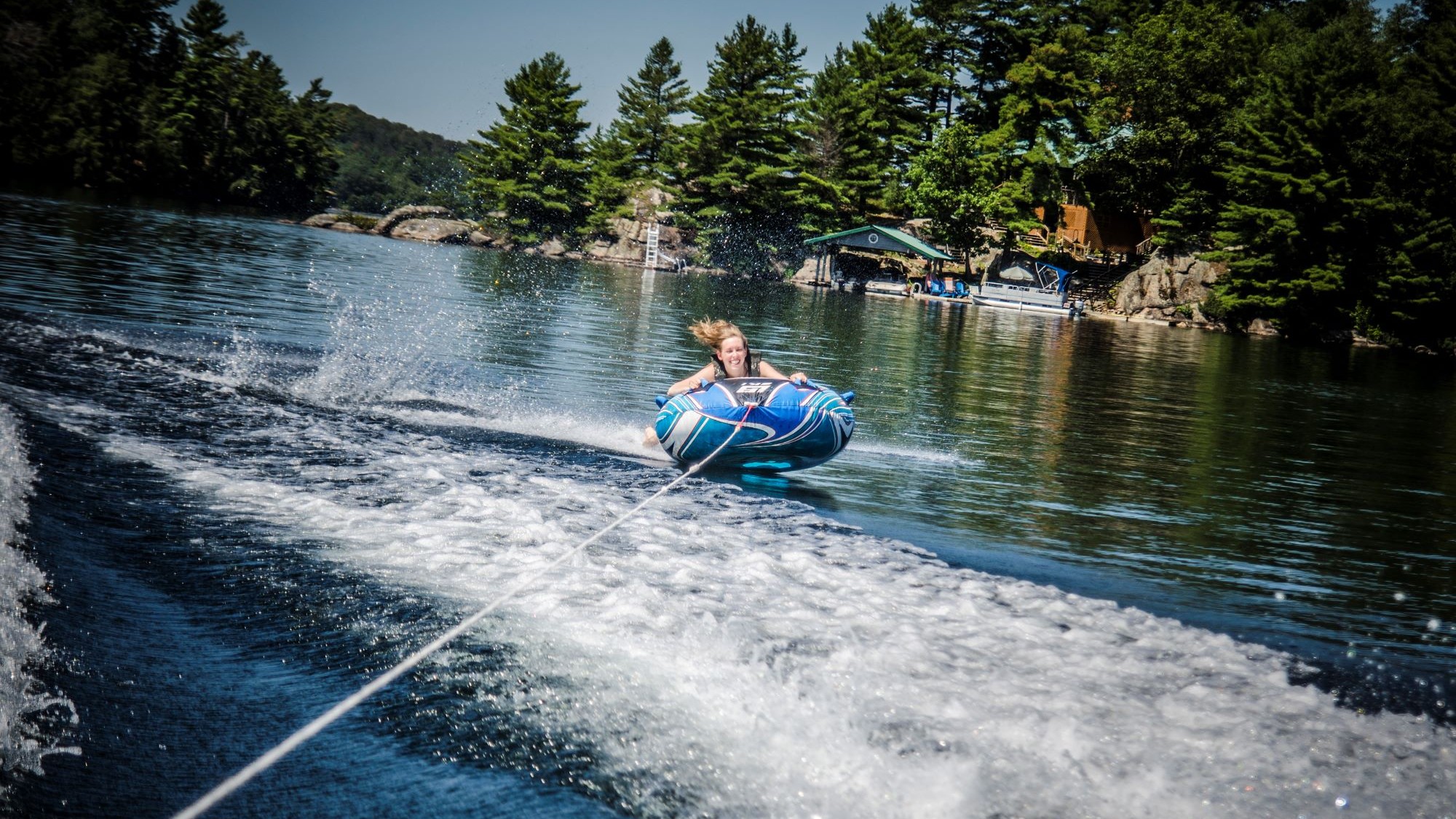 Bowrider boat pulling tubers across the water