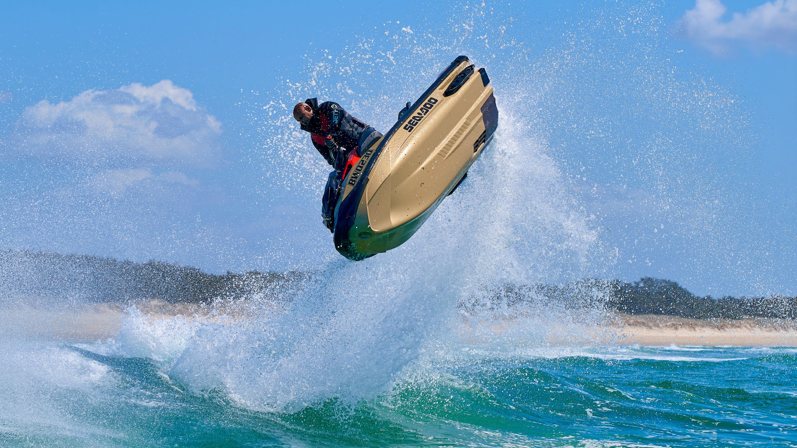 PWC rider jumping over ocean waves at high speed