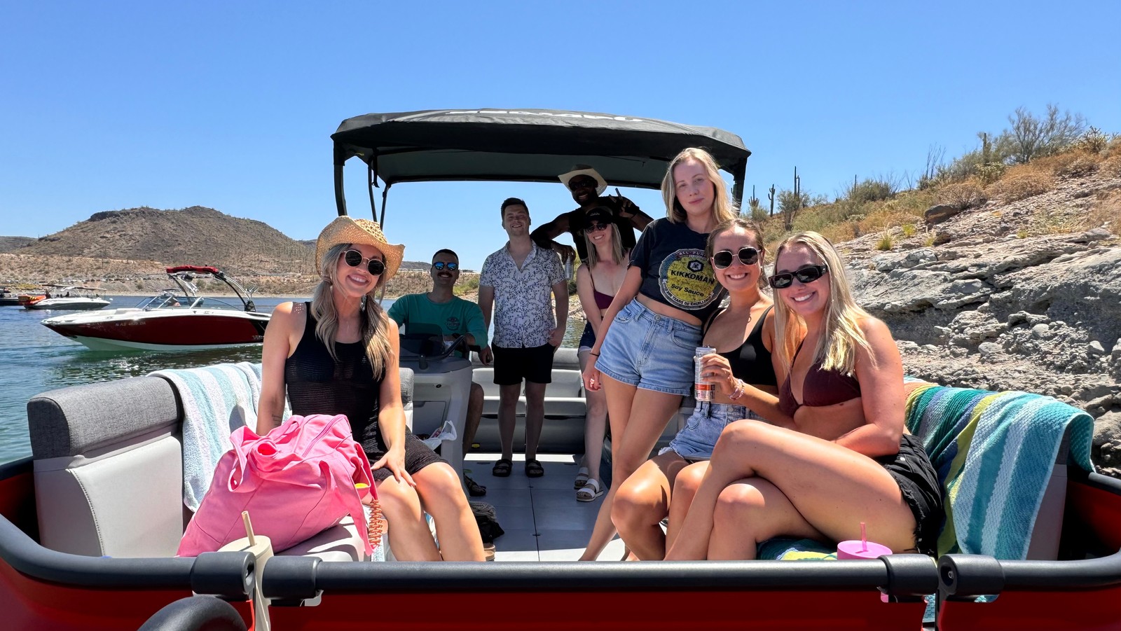 Group of friends enjoying a day on a pontoon boat at the lake