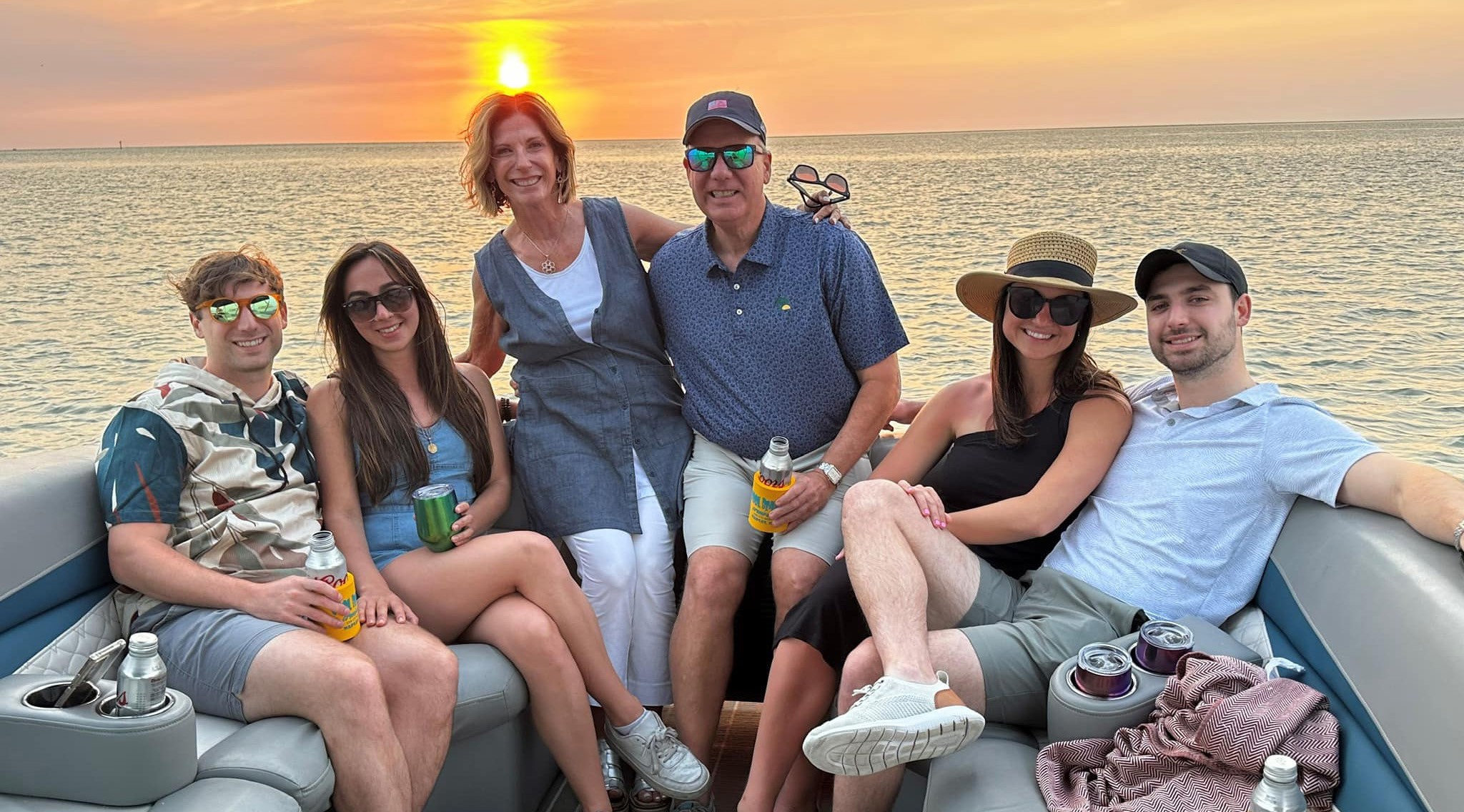 Family on a pontoon boat during a sunset cruise